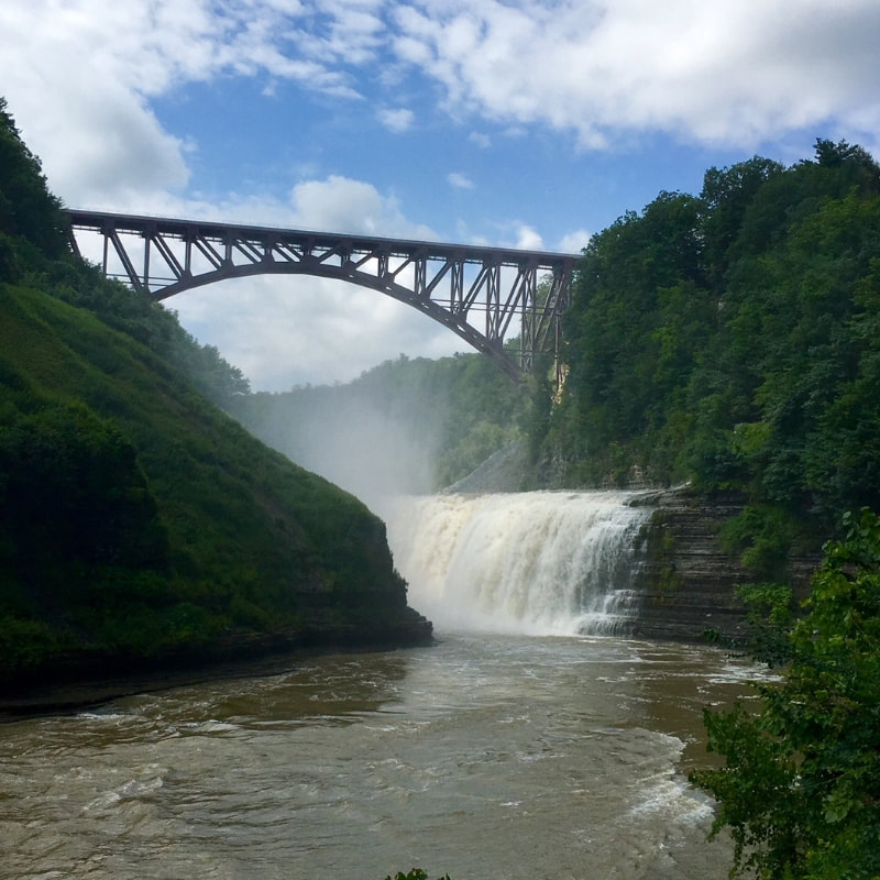 Gorgeous view of the upper falls at scenic Letchworth State Park in New York. A great stop on a road trip to Niagara Falls.